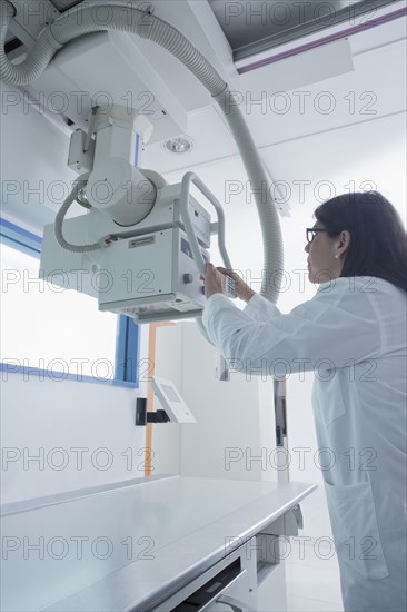 Hispanic doctor using x-ray in hospital