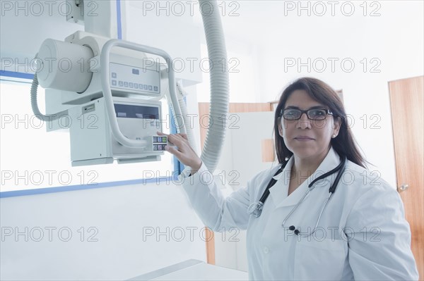 Hispanic doctor using x-ray in hospital