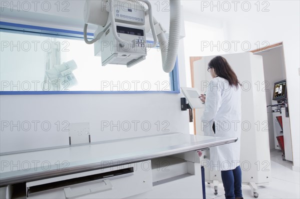Hispanic doctor using x-ray in hospital