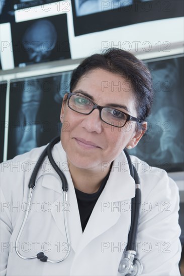 Hispanic doctor smiling in hospital