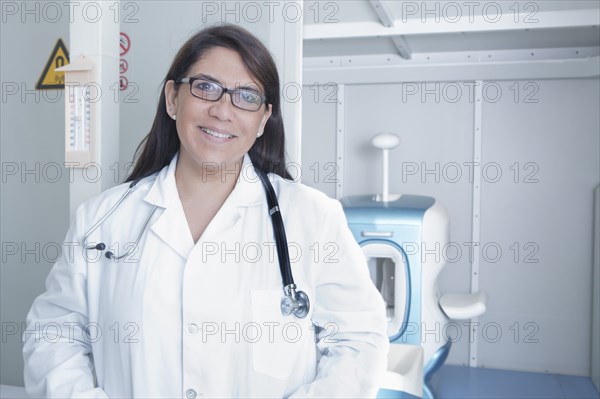 Hispanic doctor smiling in hospital