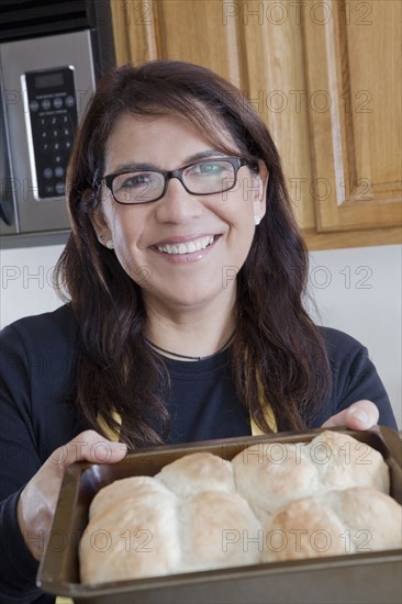 Hispanic woman baking in kitchen