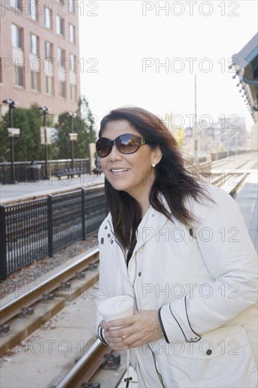 Hispanic woman waiting for train