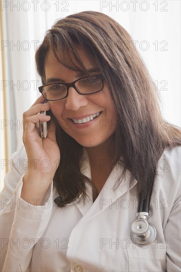 Hispanic doctor talking on cell phone