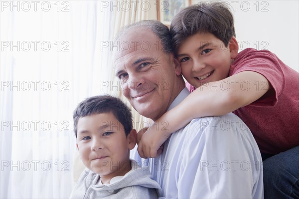 Smiling Hispanic father and sons