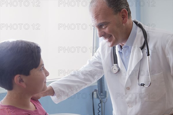 Hispanic doctor comforting boy