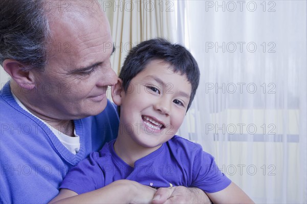 Hispanic father hugging son