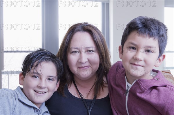 Hispanic mother posing with sons