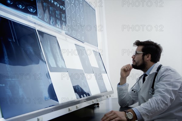 Hispanic doctor examining x-rays