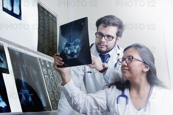 Hispanic doctors examining x-rays