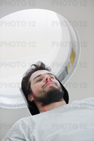 Lines on face of Hispanic patient in scanner