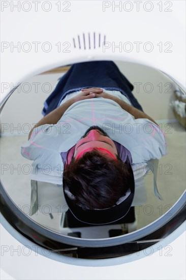 Lines on face of Hispanic patient in scanner