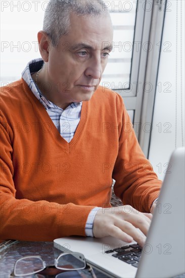 Hispanic man using laptop