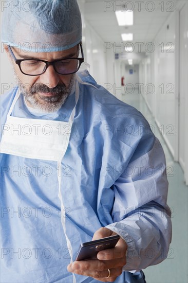 Hispanic surgeon texting on cell phone