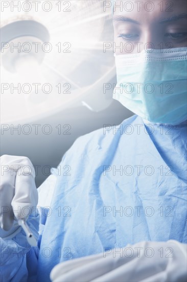 Hispanic surgeon holding scalpel