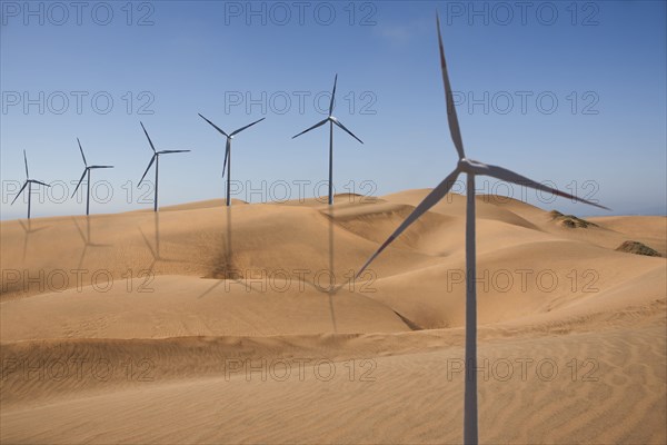 Row of wind turbines in desert