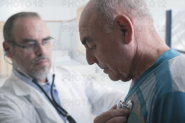 Hispanic doctor examining patient with stethoscope