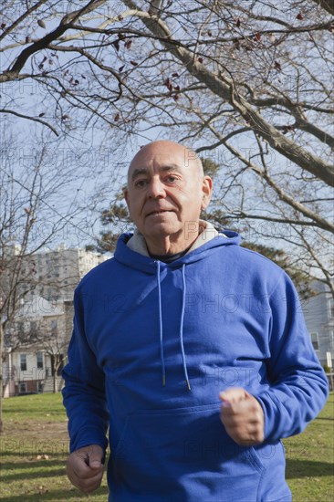 Hispanic man jogging in park