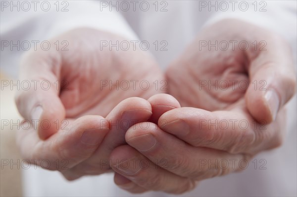 Cupped hands of Hispanic doctor