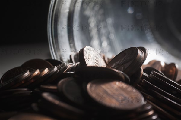 Pile of pennies near jar