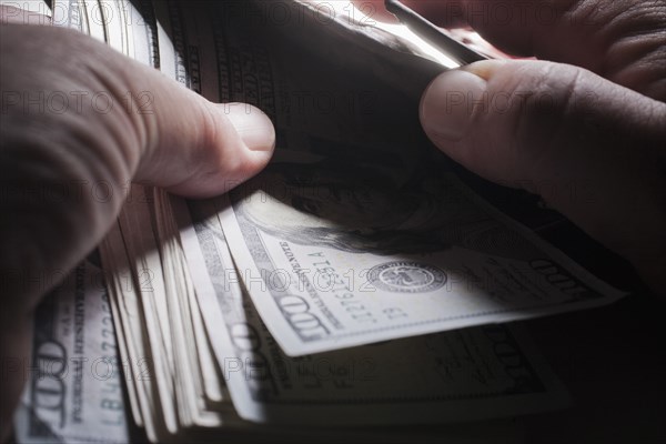 Hands of man counting money