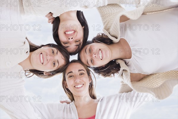 Hispanic women hugging in circle