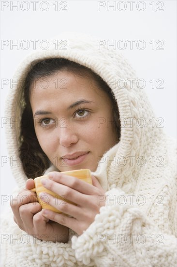 Hispanic woman drinking coffee