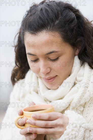 Hispanic woman drinking coffee