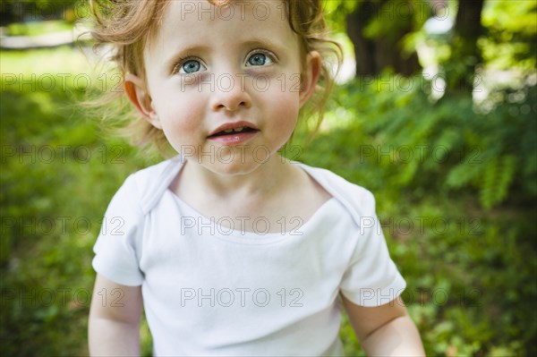 Serious girl standing outdoors