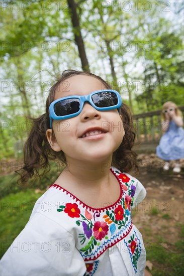 Girl in sunglasses standing outdoors