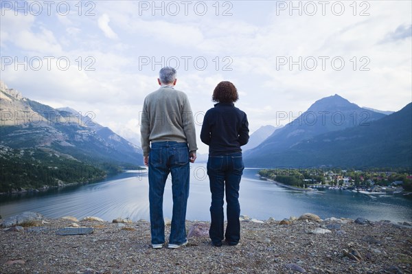 Caucasian couple standing outdoors with mountains in background