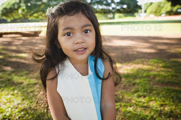 Smiling girl standing outdoors