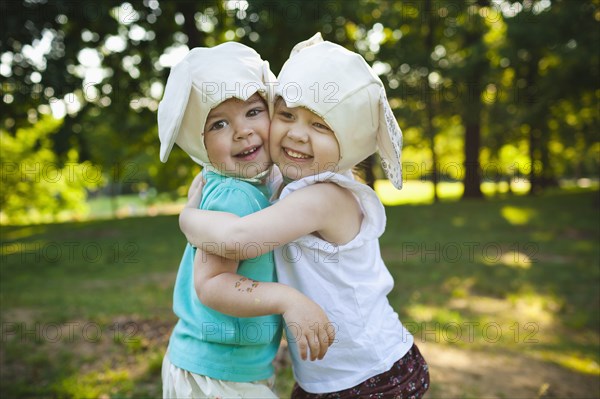 Smiling girls in mouse costume hugging