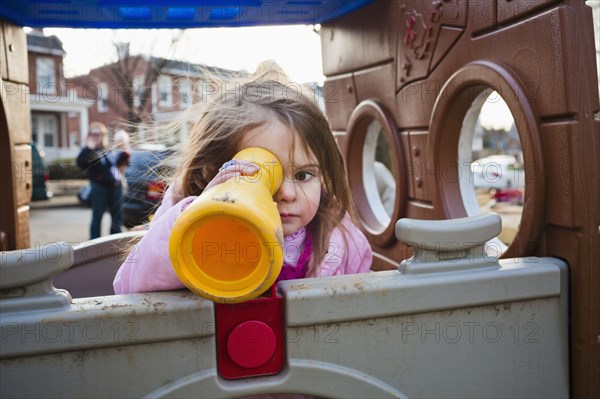 Caucasian girl playing in playground