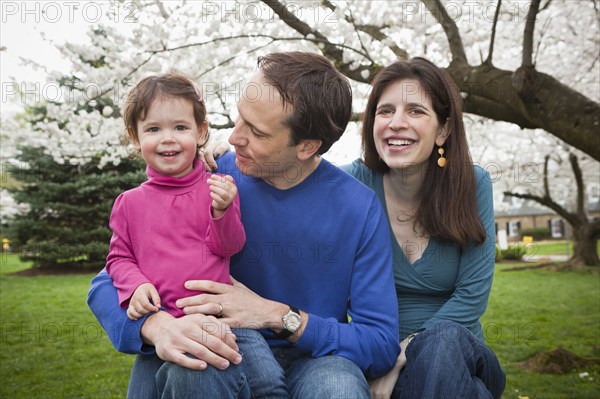 Caucasian family sitting together outdoors