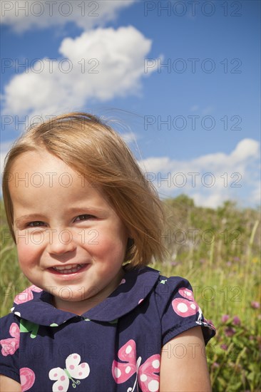 Smiling mixed race girl standing outdoors
