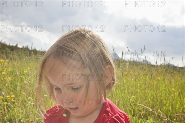 Mixed race girl standing in field