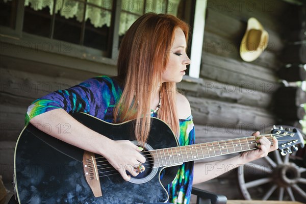 Caucasian woman playing guitar