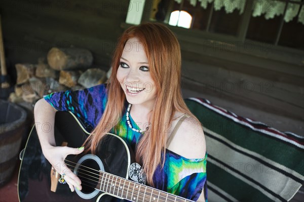 Caucasian woman playing guitar