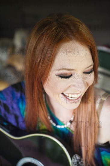 Caucasian woman playing guitar