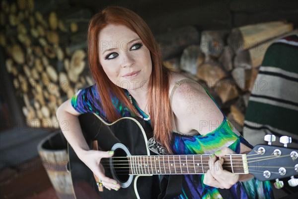 Caucasian woman playing guitar