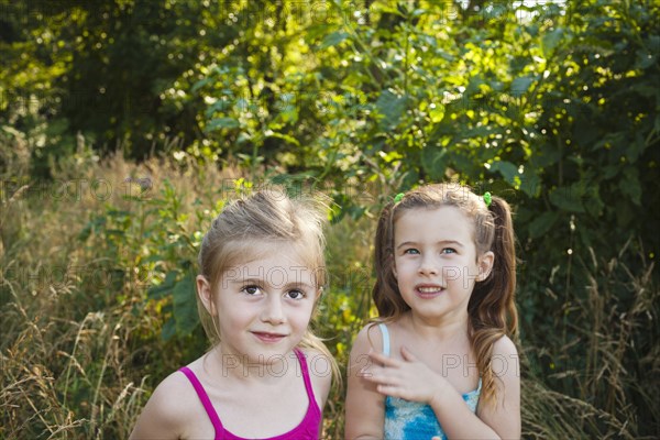 Caucasian girls standing in woods