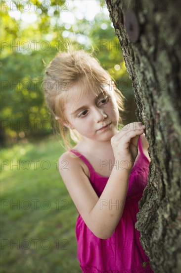 Caucasian girl looking at tree