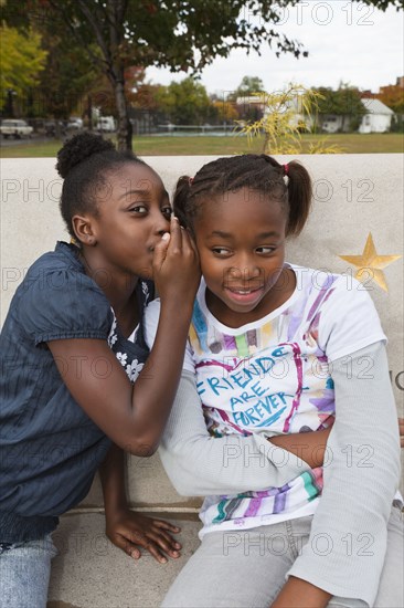 Black girls whispering together