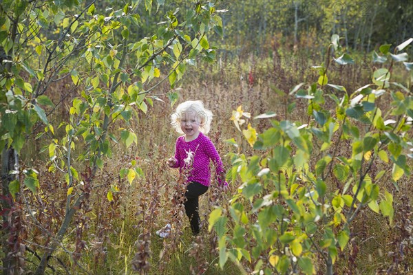 Caucasian girl walking in rural meadow