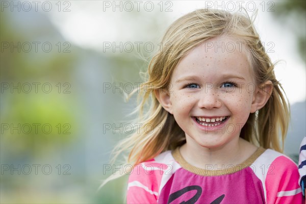 Smiling girl standing outdoors