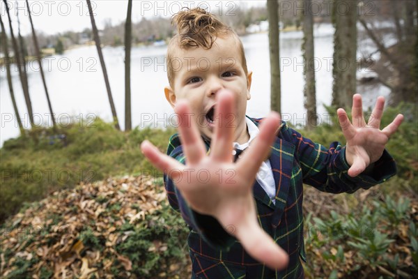 Mixed race boy shouting outdoors