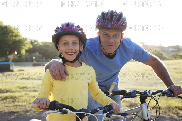 Caucasian father and son riding bicycles