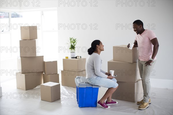 Couple with cardboard boxes in new home