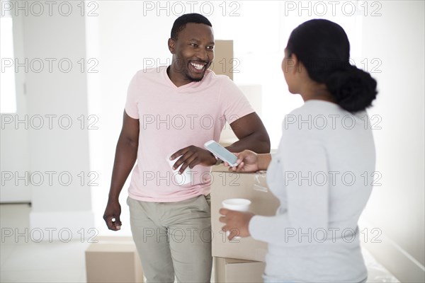 Couple with cardboard boxes in new home